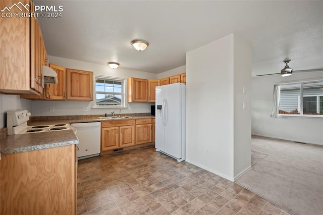 kitchen with sink, light colored carpet, white appliances, and ceiling fan