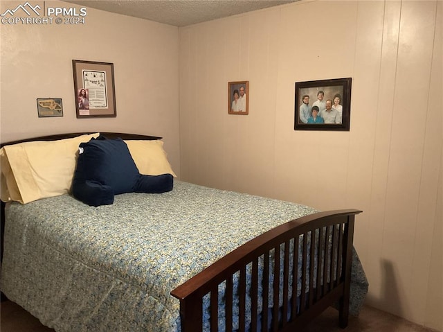 bedroom featuring wood walls