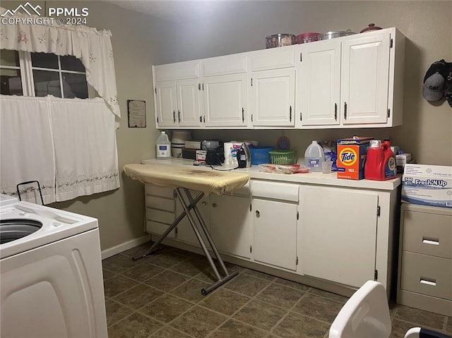 clothes washing area with washer / clothes dryer and cabinets