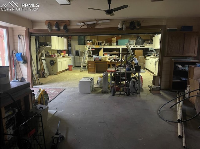 garage with stainless steel fridge with ice dispenser and ceiling fan