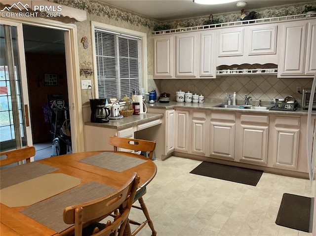 kitchen featuring sink, white cabinets, and tasteful backsplash