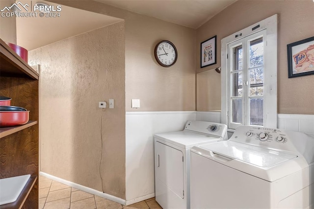 laundry area with washing machine and dryer and light tile patterned flooring