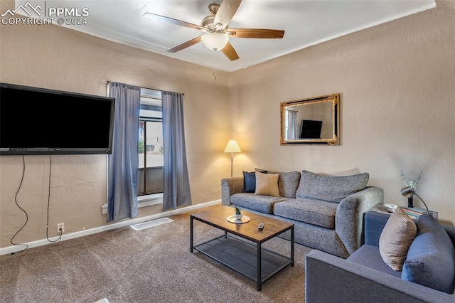 living room featuring ceiling fan, crown molding, and carpet floors