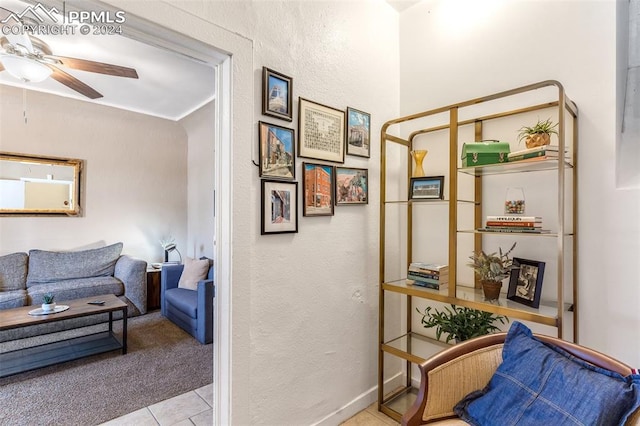 sitting room featuring light tile patterned flooring and ceiling fan