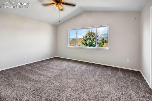 spare room with ceiling fan, vaulted ceiling, and carpet floors