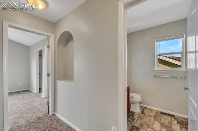 hallway with light colored carpet