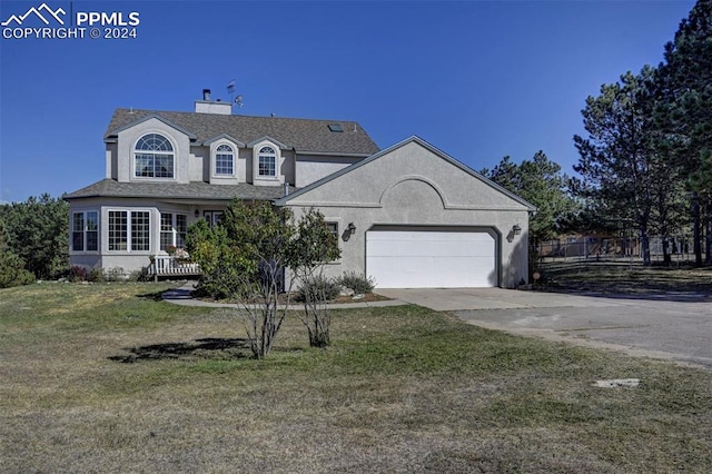 view of front of home with a front lawn and a garage