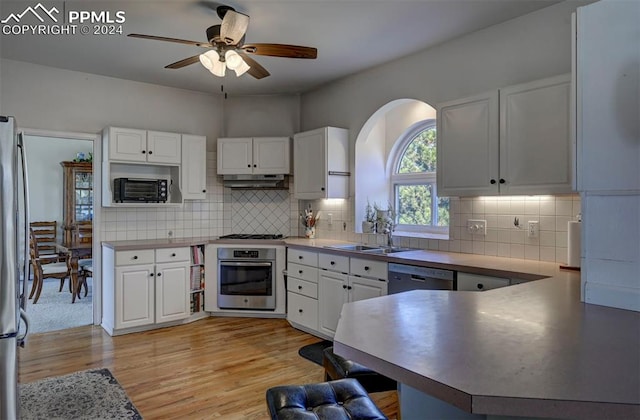 kitchen featuring sink, light wood-type flooring, ceiling fan, stainless steel appliances, and white cabinets