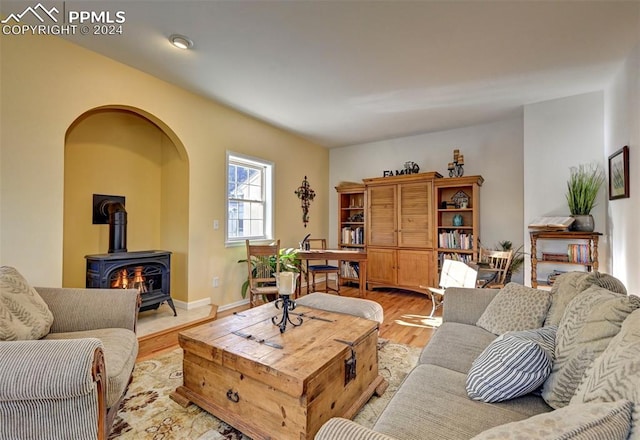 living room featuring light hardwood / wood-style flooring and a wood stove