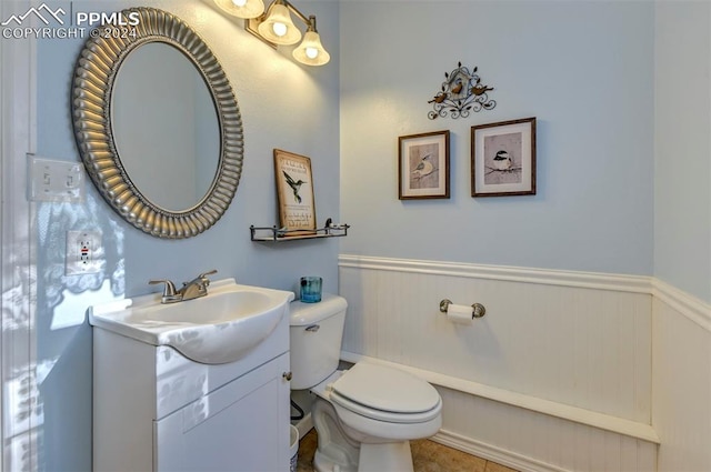 bathroom featuring vanity, toilet, and tile patterned flooring