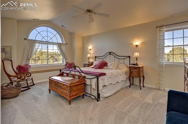 bedroom featuring ceiling fan, multiple windows, and light colored carpet