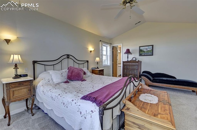 carpeted bedroom featuring ensuite bath, vaulted ceiling, and ceiling fan