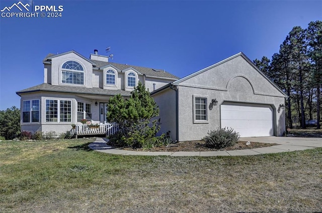 view of front of property with a front yard and a garage