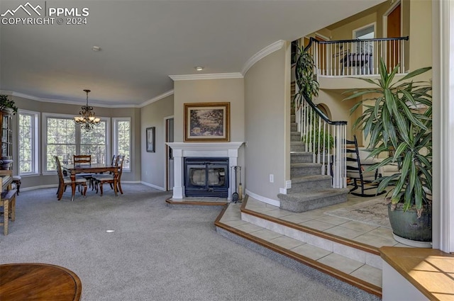 living room with crown molding, carpet floors, a notable chandelier, and a tile fireplace