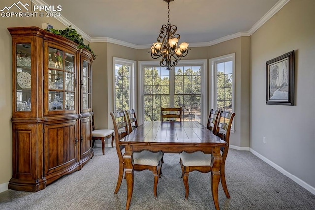 dining area featuring a wealth of natural light, ornamental molding, and a chandelier