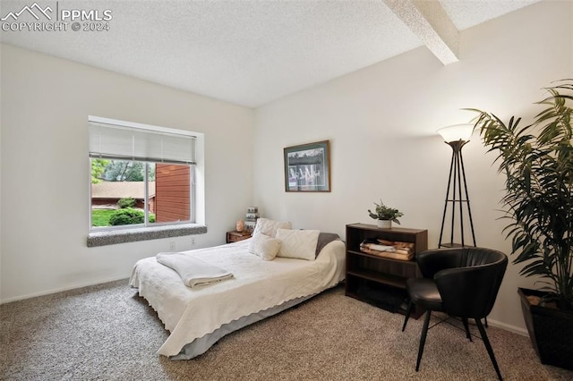 carpeted bedroom with a textured ceiling and beam ceiling