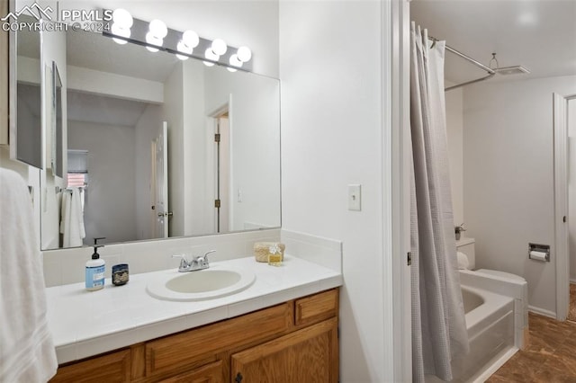 full bathroom featuring vanity, shower / tub combo with curtain, and toilet