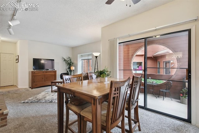 dining room featuring a textured ceiling, ceiling fan, light colored carpet, and rail lighting