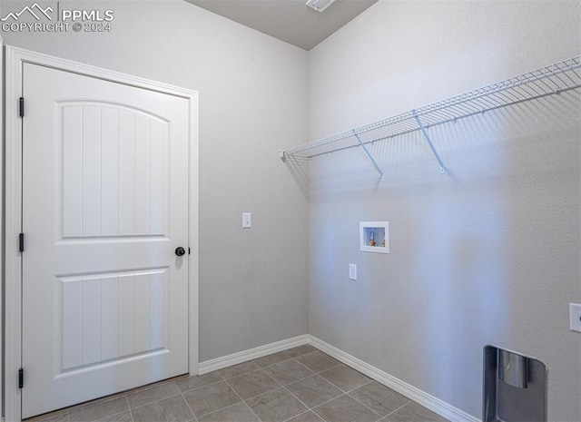 clothes washing area with washer hookup and light tile patterned floors