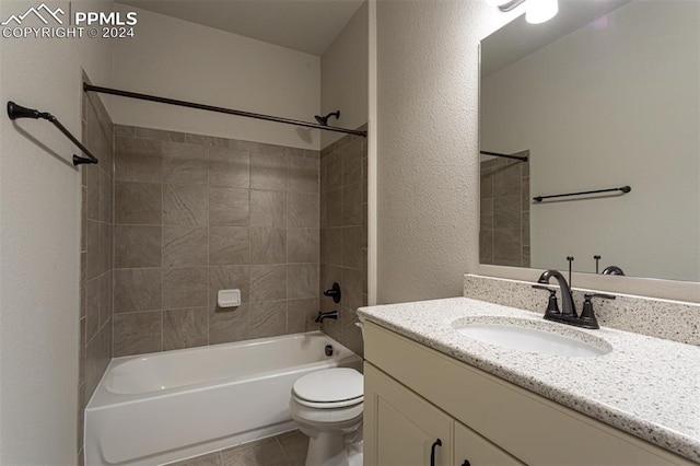 full bathroom with toilet, tiled shower / bath combo, vanity, and tile patterned flooring