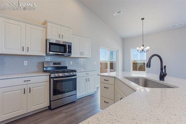 kitchen featuring white cabinetry, hardwood / wood-style floors, stainless steel appliances, and sink