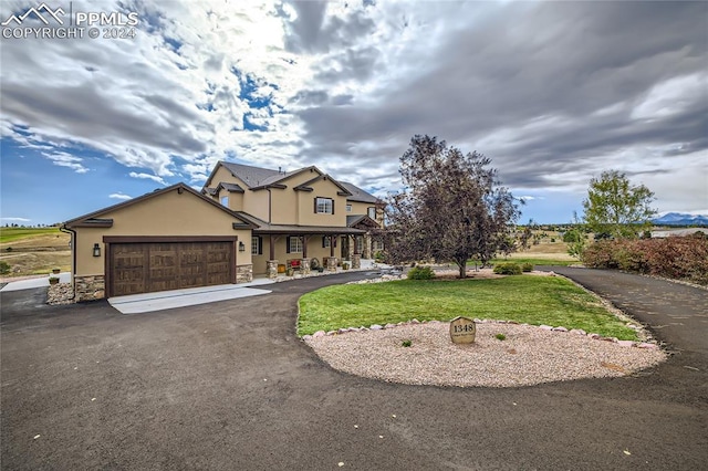 view of front of home featuring a garage and a front lawn