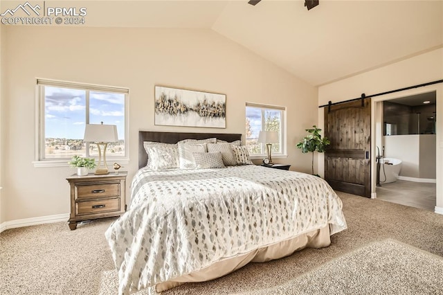 bedroom with ensuite bathroom, carpet, lofted ceiling, and a barn door