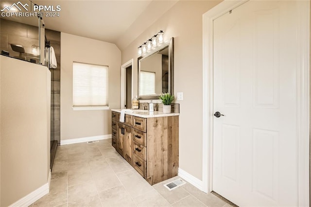 bathroom featuring vanity, tile patterned floors, and a shower with door