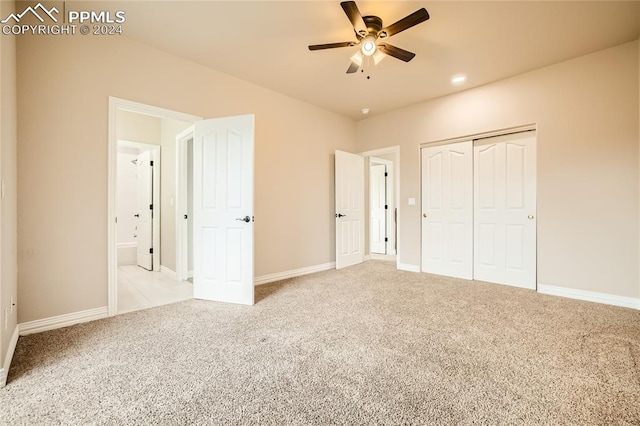 unfurnished bedroom with a closet, ceiling fan, and light colored carpet