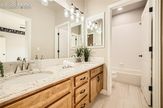 full bathroom with vanity, toilet, and shower / washtub combination