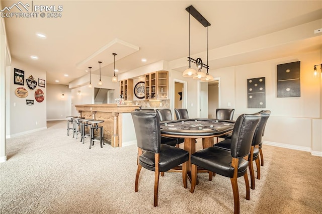 dining room with light colored carpet and indoor bar