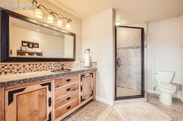 bathroom with backsplash, an enclosed shower, toilet, vanity, and tile patterned flooring