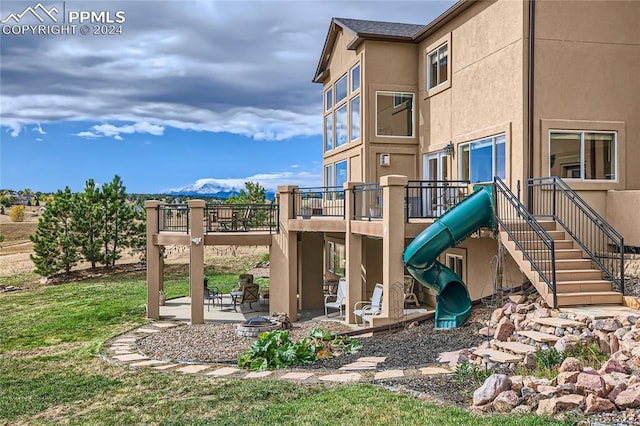 view of playground with a patio