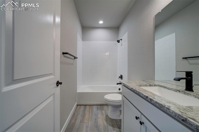 full bathroom featuring vanity, toilet, hardwood / wood-style flooring, and  shower combination