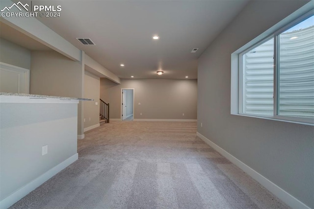 unfurnished room featuring light colored carpet