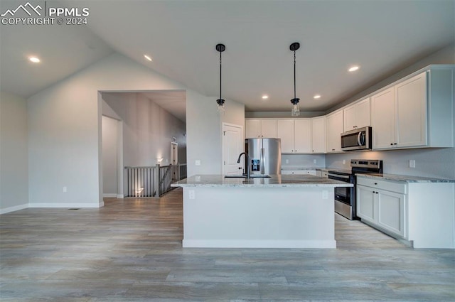 kitchen with stainless steel appliances, a kitchen island with sink, and white cabinets