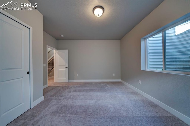 unfurnished bedroom with light carpet