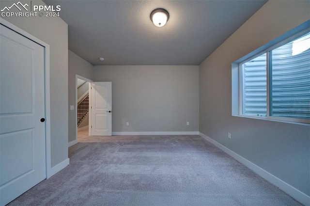 unfurnished bedroom featuring light carpet