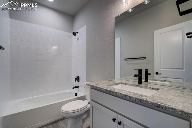 full bathroom with vanity, toilet, wood-type flooring, and tub / shower combination