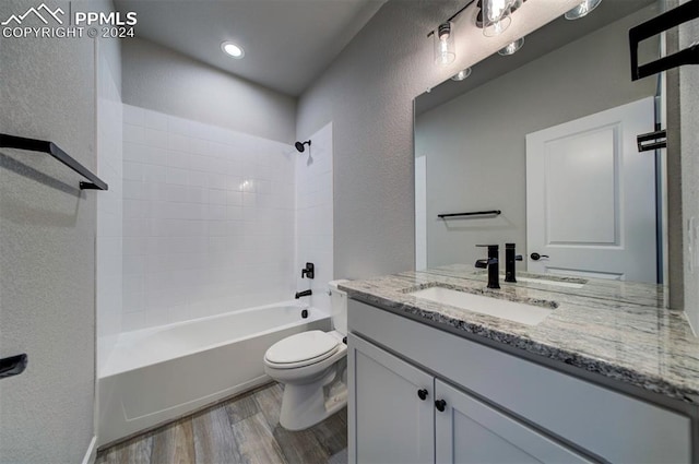 full bathroom featuring vanity, toilet, wood-type flooring, and shower / bathtub combination