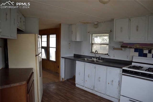 kitchen with white appliances, sink, white cabinetry, exhaust hood, and dark hardwood / wood-style floors