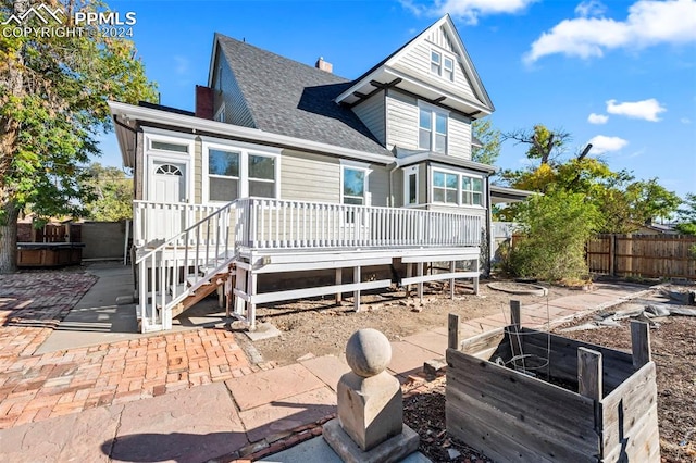 back of house featuring a patio area and a deck