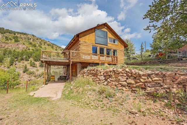 back of house with a wooden deck