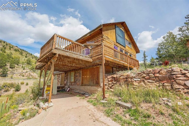 view of side of property featuring a wooden deck