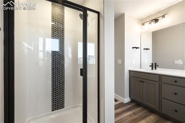 bathroom featuring vanity, hardwood / wood-style flooring, and an enclosed shower