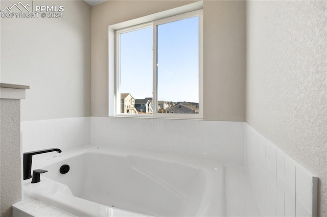 bathroom with a tub to relax in