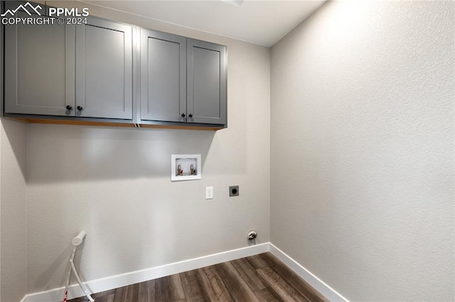 washroom featuring washer hookup, dark hardwood / wood-style flooring, cabinets, and hookup for an electric dryer