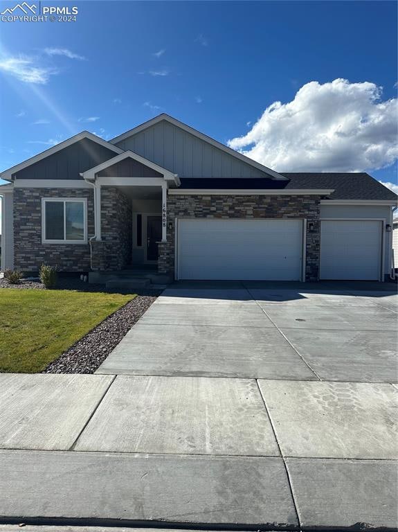 view of front of property with a front lawn and a garage