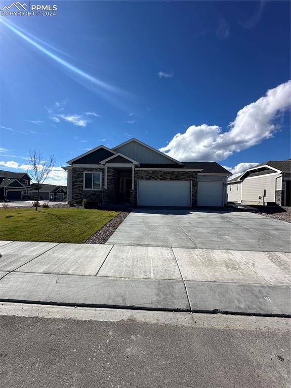 ranch-style home featuring a front yard and a garage