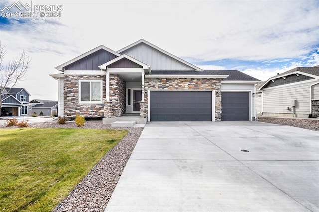 view of front of property with a front yard and a garage